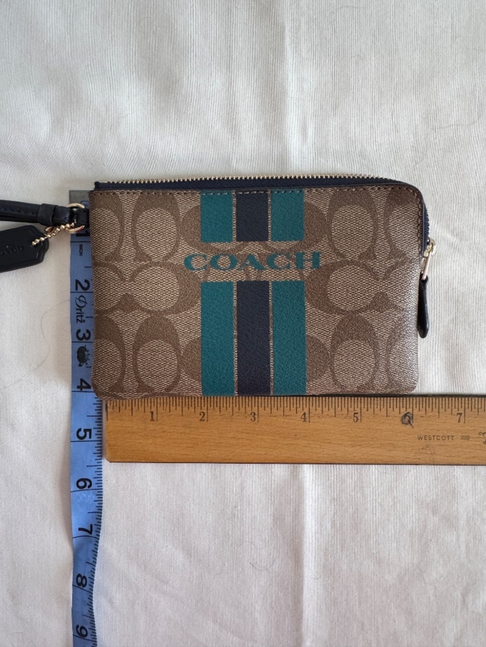 Coach Wristlet Tan/Brown monogram with teal and blue stripes and navy blue strap